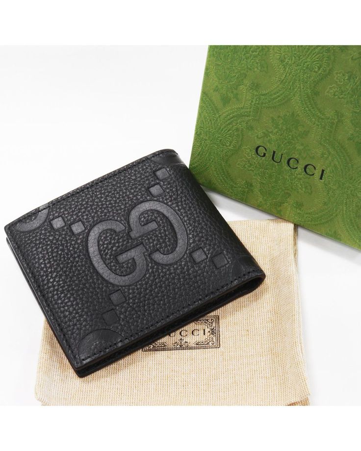 Authentic Gucci Jumbo GG bi-fold wallet in black calfskin leather with debossed GG logo