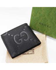 Authentic Gucci Jumbo GG bi-fold wallet in black calfskin leather with debossed GG logo