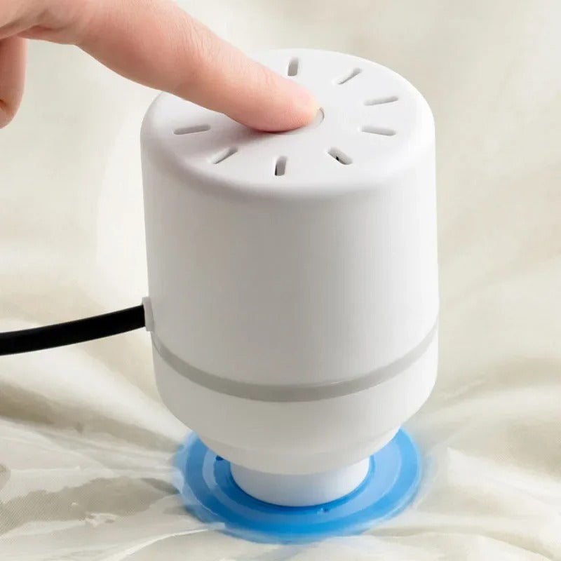 Compact electric vacuum pump connected to vacuum storage bag compressing clothes to save 80% space
